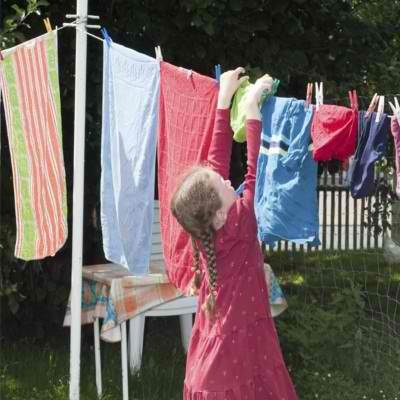 girl hangs out the washing