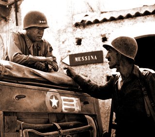 Patton speaking with Lt. Col. Lyle Bernard, at Brolo, circa 1943.