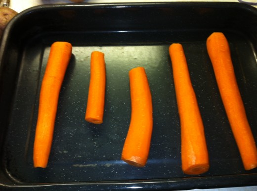 Place carrots into the bottom of the roasting pan