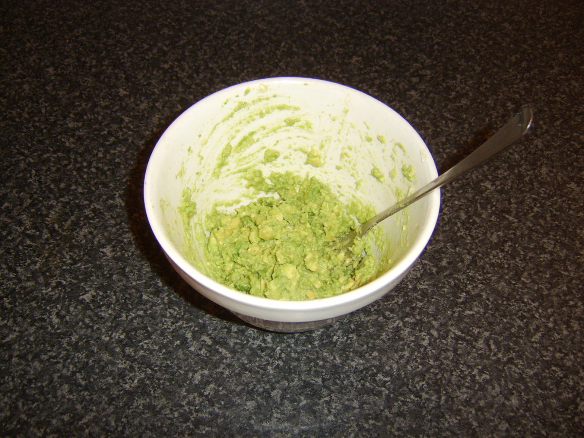 Avocado is mashed with a fork to provide texture