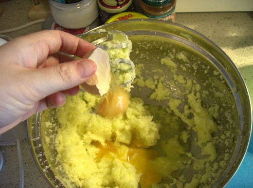 Now you want to break your eggs into the creamed butter and sugar and mix everything together well with your hand mixer. 