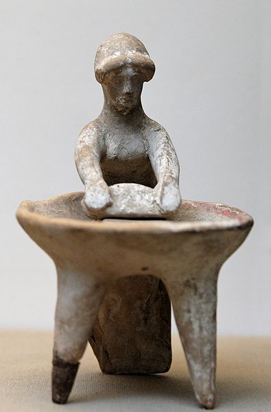 Woman grinding weat in a basin. Terracotta, Greek artwork, ca. 450 BC. From Kameiros, Rhodes