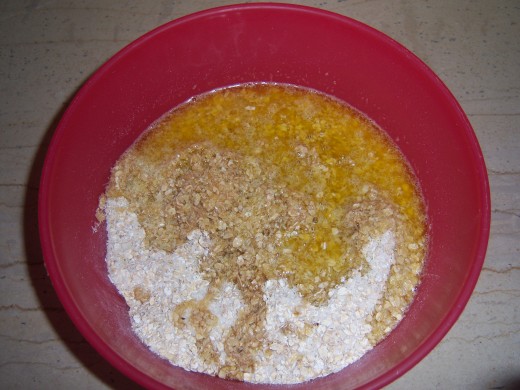 5. Add the melted butter or margarine, sugar and honey to the oats and coconut....