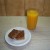Chewy honey, oat and coconut flapjacks with a glass of fresh orange juice....