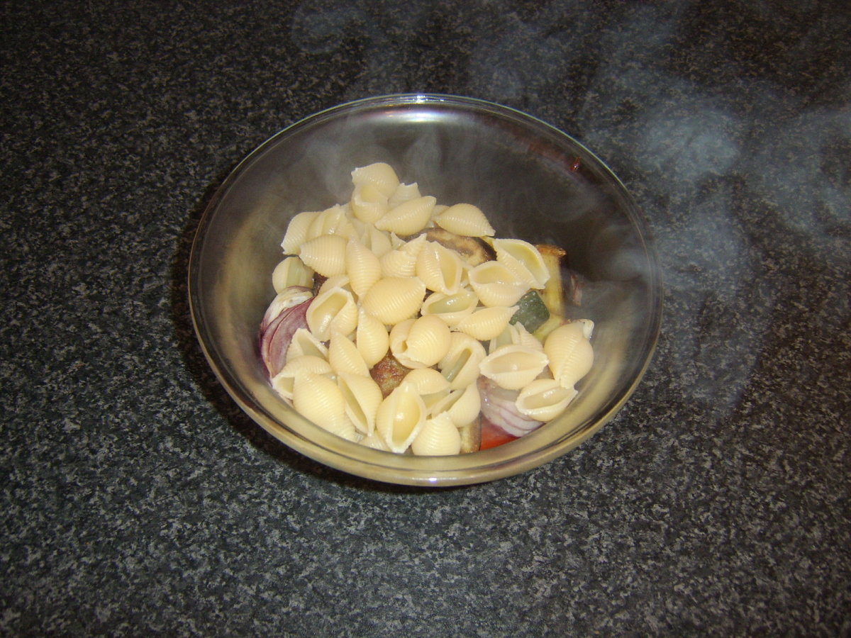 The pasta shells are added to the vegetables and carefully folded through
