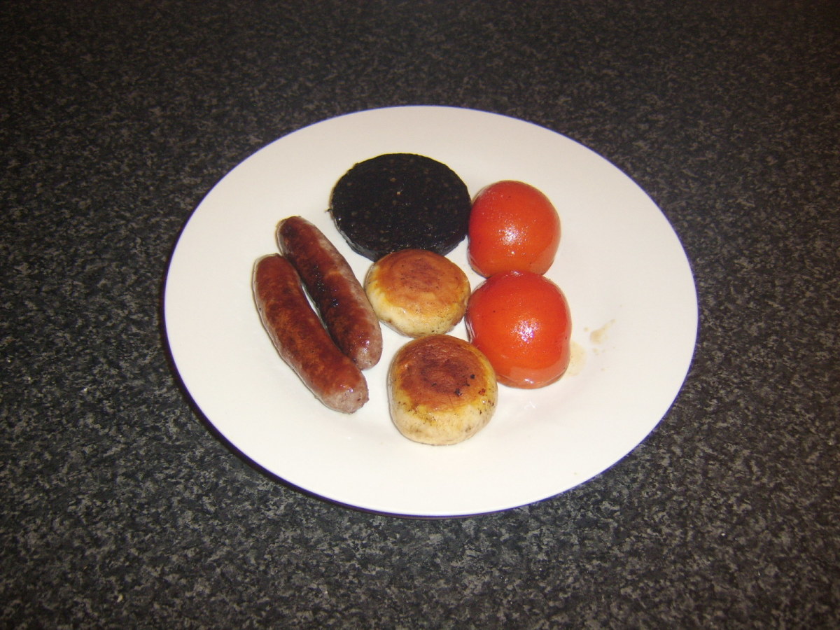 The sausage, black pudding and veg are kept warm on a heated plate