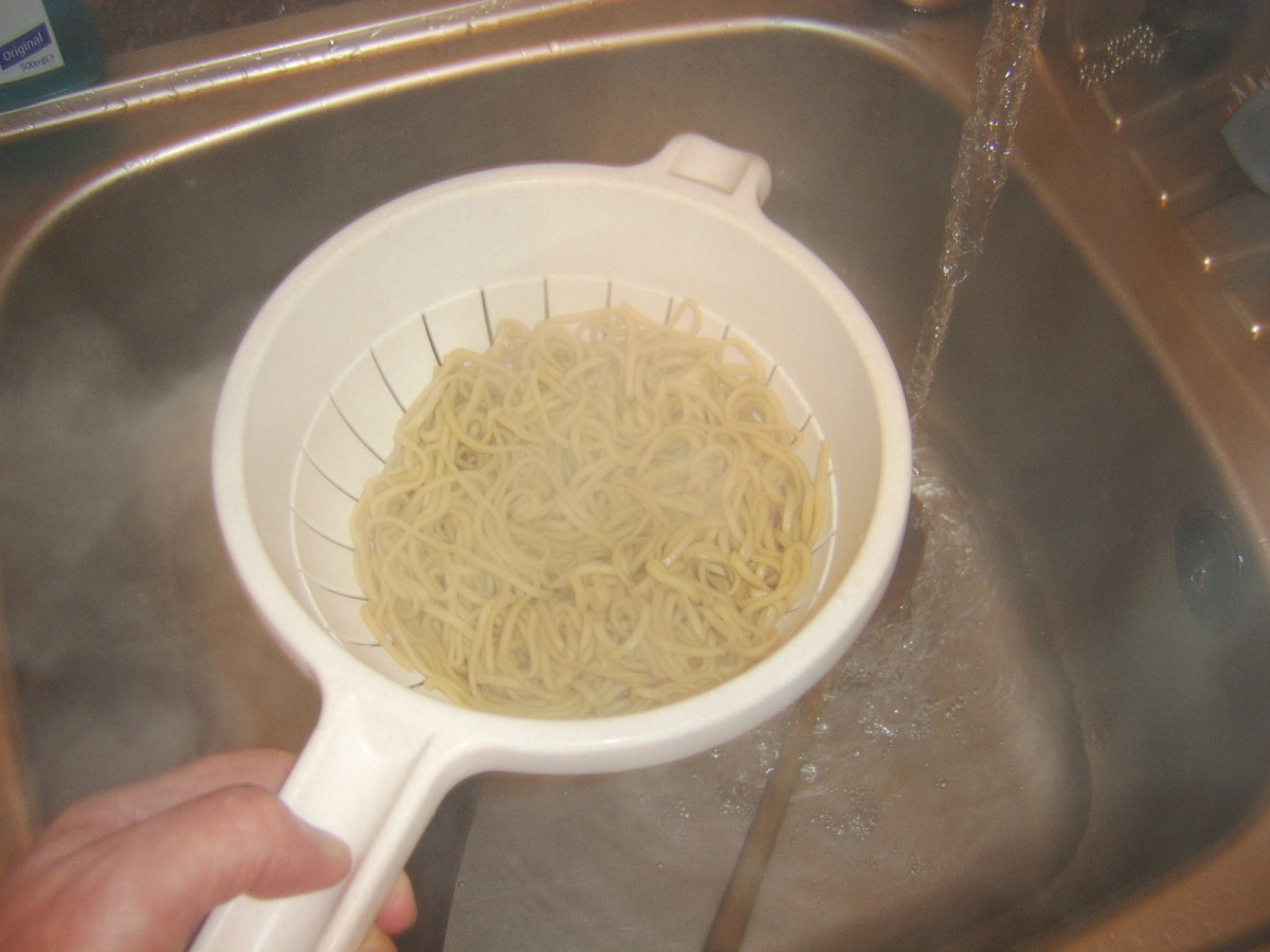 Noodles are drained through a colander