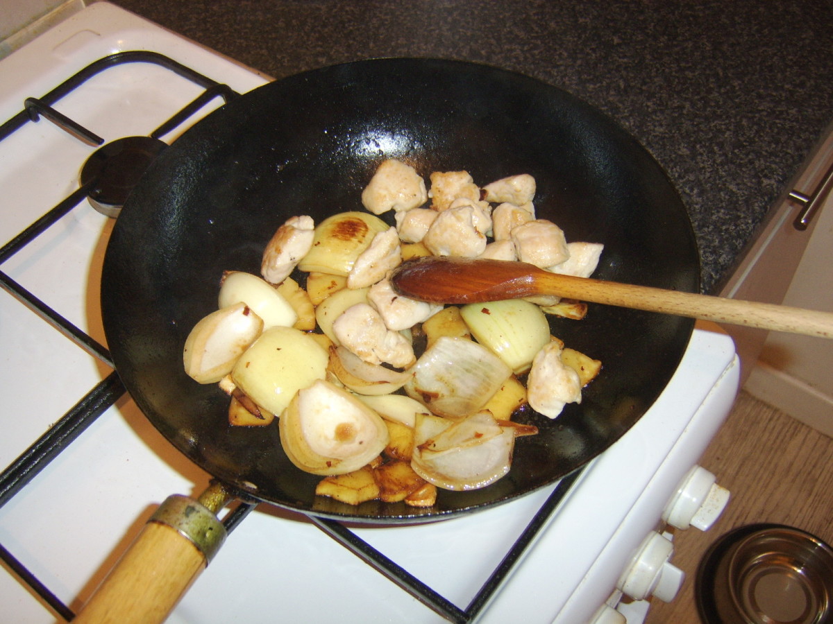 Chicken is returned to the wok to complete cooking
