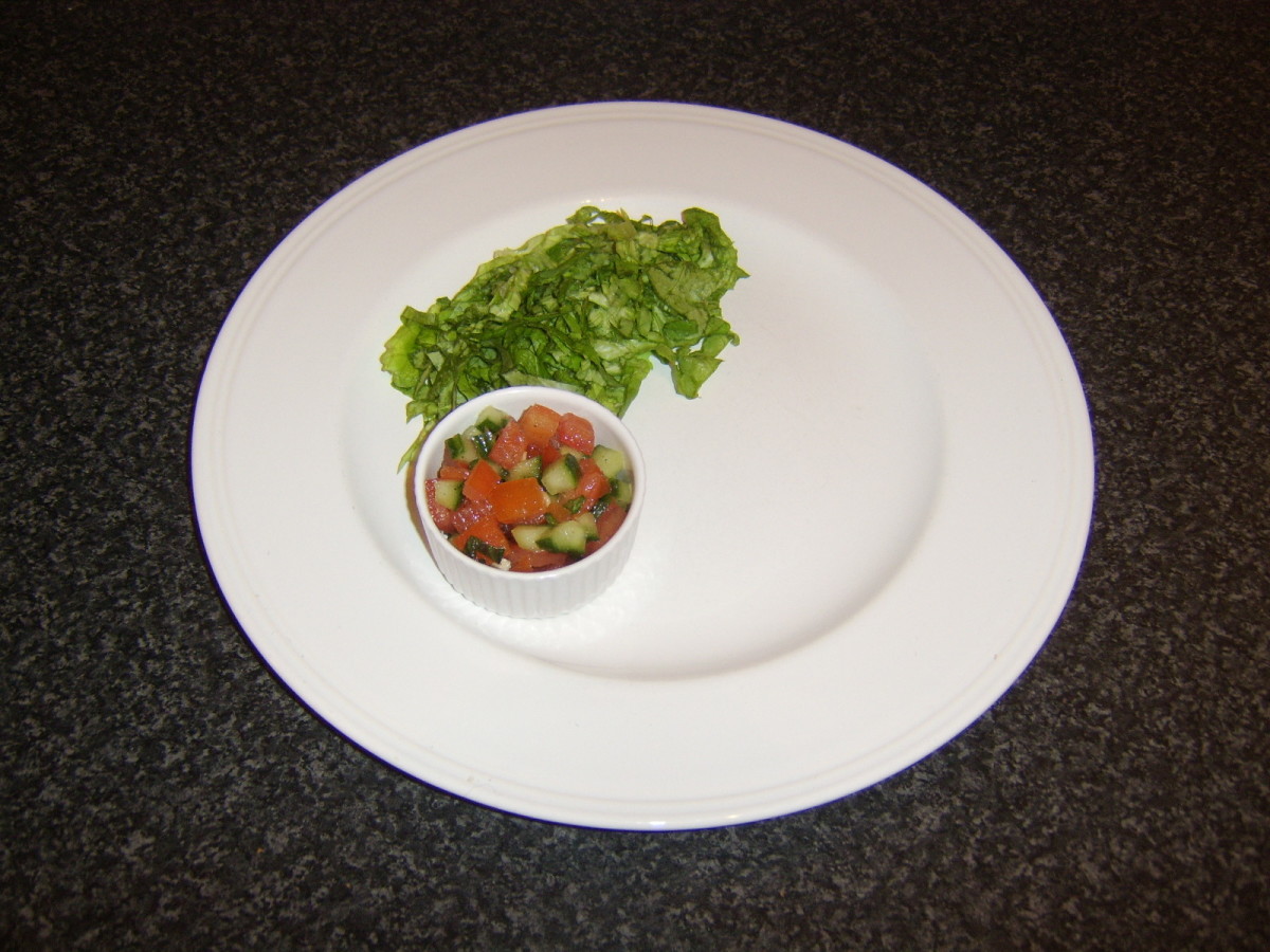 Shredded lettuce and salsa are plated in readiness