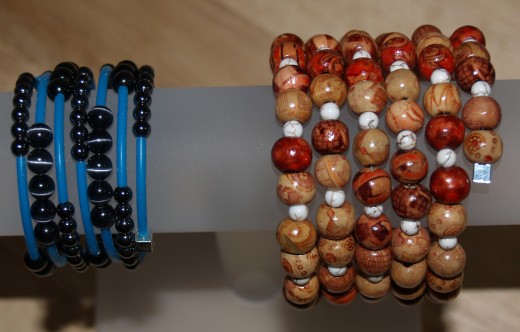 Rubber tube cord, Hematite beads, and cat's eye beads were used in the bracelet on the left.  Painted wooden beads and magnesite beads were used in the bracelet on the right.