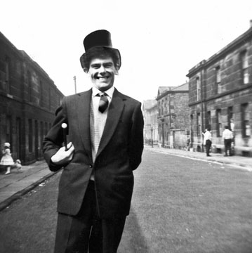 My uncle Tommy standing on the street outside my grandparents old home