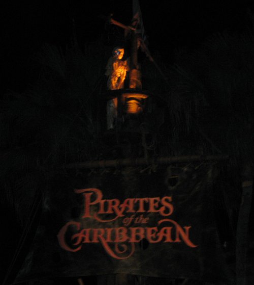 Entrance to Pirates of the Carribean, lit up at night.