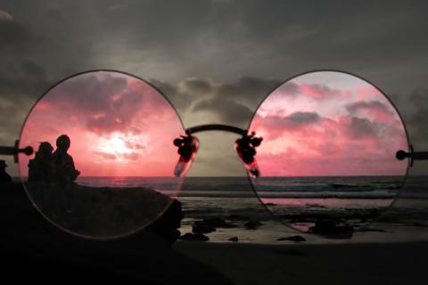 Seeing the world through rose colored glasses.