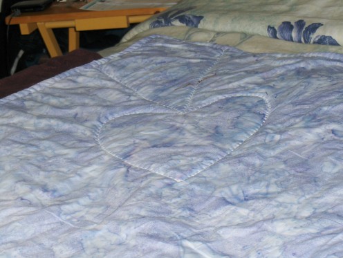 The pattern is an enlarged pattern of the quillow top and this is the reverse side.  Both sides of the quilt part are one large piece of fabric.  These are all batik fabrics. 100% cotton
