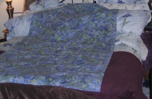 This quilt has no binding.  It was three layers the same size sew like an envelope flipped and embroidery stitched around the edge.  