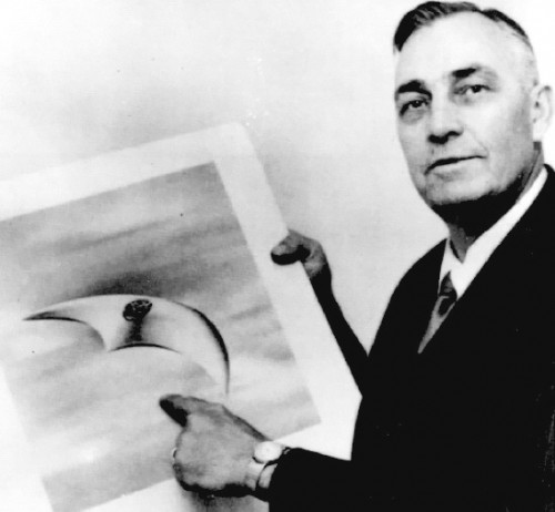 Kenneth Arnold with artist's rendering of of the crescent shaped UFO he saw in 1947. 
