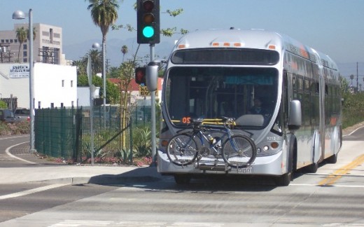 Orange Line bus proceeds slowly through intersection on "rapid transit" busway. Collisions at intersections have been reduced, but the requirement to stop or travel slowly has degraded service.