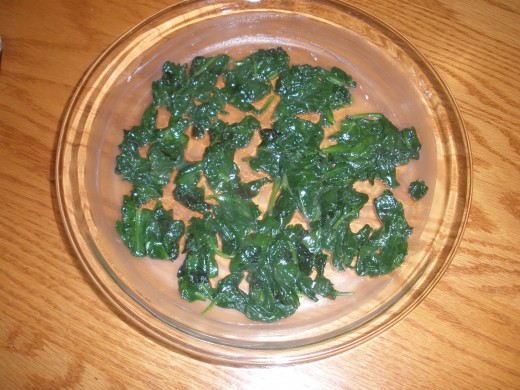 Place the spinach in the dish on top of the melted butter. 