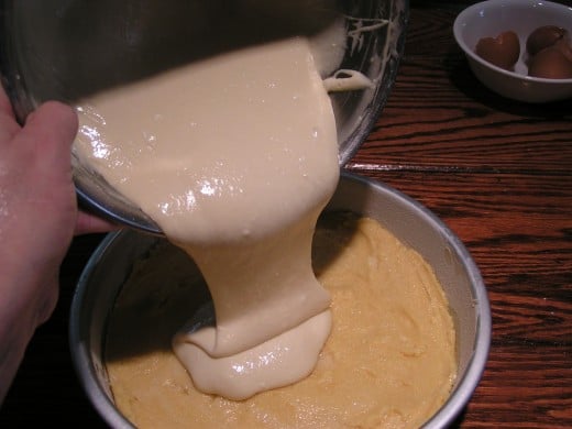 Pour cream cheese mixture over cake mixture pressed into pan.