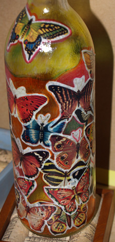 Detail of completed wine bottle project. Note the use of the stained glass marking pens in the open spaces between the glued images.
