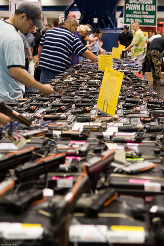 Wares and weapons on display at a Houston Gun Show.  (Photo credit and thanks to Michael Glasgow under Creative Commons) 