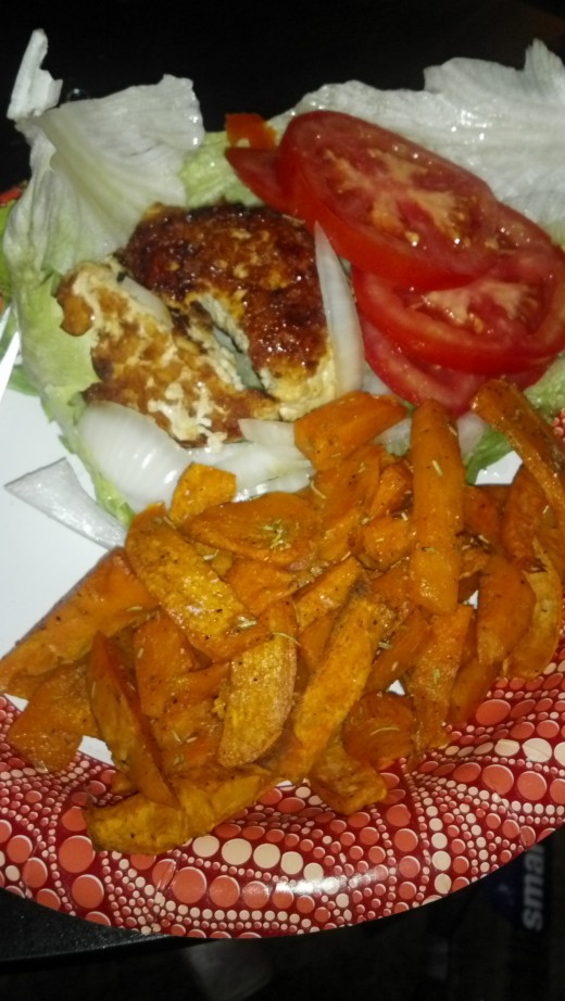 Chicken Burger on a bed of lettuce, Sweet Potato Fries.  