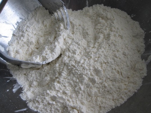 Using pastry blender to combine butter with flour mixture. Blend until texture of fine granules.