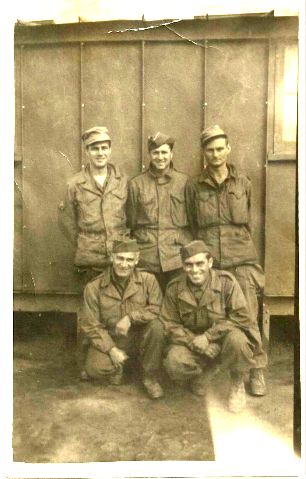 My dad is the handsome man with the big smile kneeling in front on the right.  This photo was taken at "Camp Washington, D.C.," Reims, France, Sept. 24, 1945.