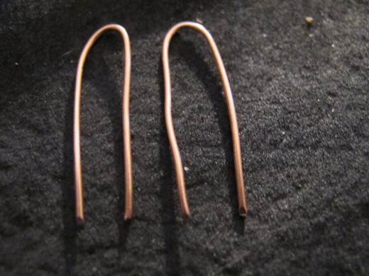 Create two even ear wires by centering and bending the wire lengths.
