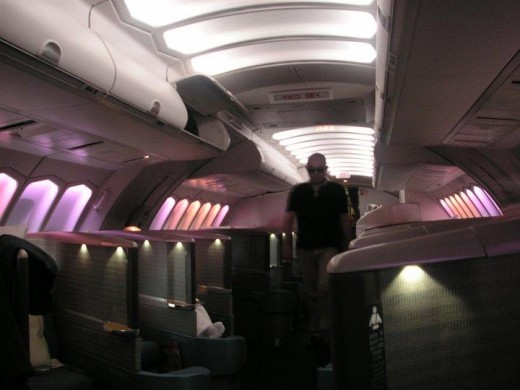 The upper deck business class cabin has a 1x1 herringbone configuration with outward angled seats