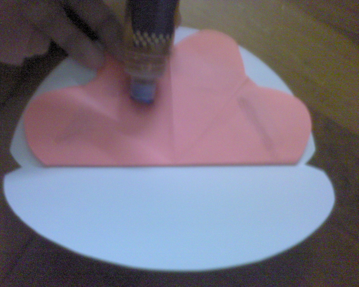 apply glue at the back of pink paper