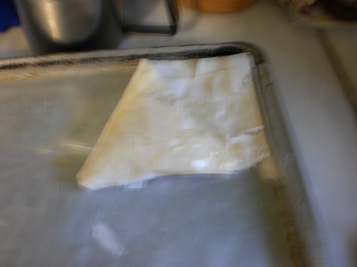 Ending, use butter to seal excess phyllo.