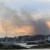 smoke starts to mix with sunset along the beach 