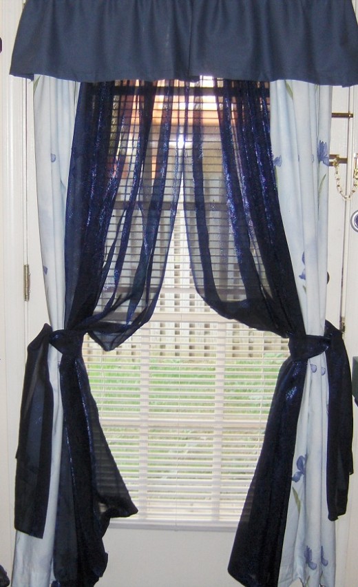 Simple Rod Pockets with Valance on Top Rod Iridescent Sheers in between and tied back together with matching iredescent sheer fabric
