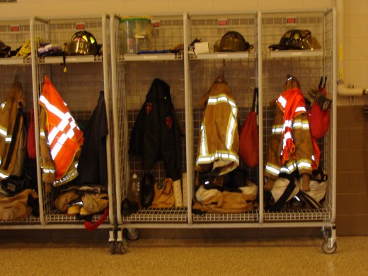 The firemen hang their fire gear in individual lockers.