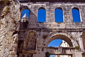 From the outside, looking in.  In the background you can see the belltower of Sveti Duje Cathedral in the Peristil. 