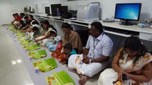 Having Onasadhya ( lunch in traditional way in banana leaf) inside the office