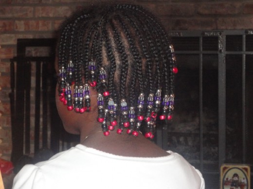 Full head cornrows with beads on all braid ends.