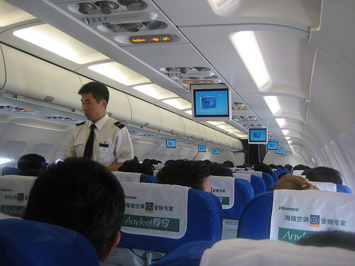male flight attendant in a flight to Hong Kong