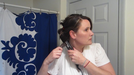 Wrap the hair around the flat iron.  Hold onto the end or "tail" and pull the hair through.