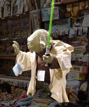 Yoda from Star Wars in a toy shop. One small body, big on miracles. 