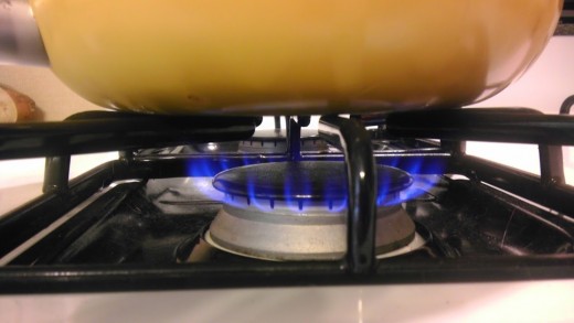 Flame on, but don't bother with the grill. Just turn on a low to medium-low flame under the pan. 