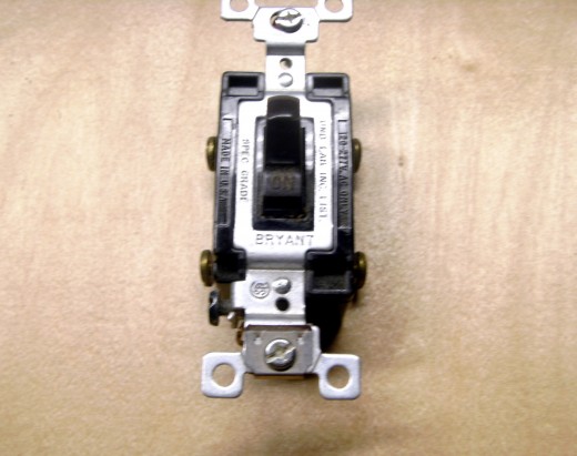 A four way switch, used in conjunction with 2 three way switches to control lighting from multiple locations.  There are four terminals to attach wires to, although none of them get a line wire.