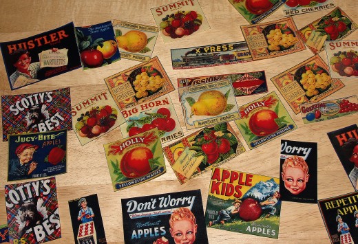 Fruit crate labels and vegetable crate labels which have been trimmed from sheets of decoupage paper.