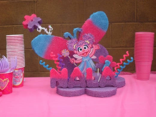 I did lots of research on Abby Cadabby centerpieces and did indeed find one to inspire me. As you can see, my styrofoam centerpiece that I airbrushed my self which took 2 days to dry, and assemble was the cutest thing on the table. 