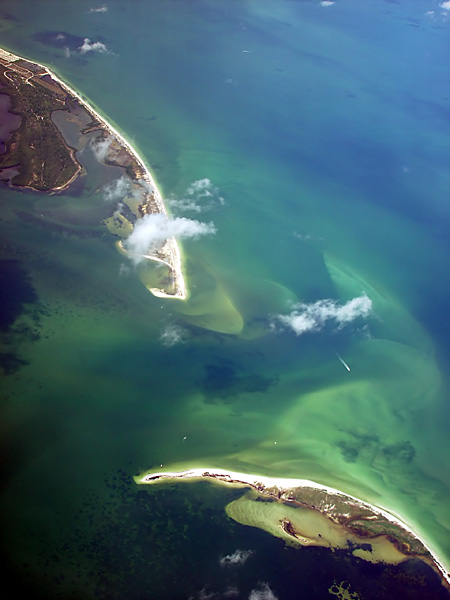 In this aerial view, Honeymoon Island is visible at the top of the picture with the northern tip of Caladesi Island at the bottom of the photo.  Originally a single island named Hog Island, it was split by the hurricane of 1921.