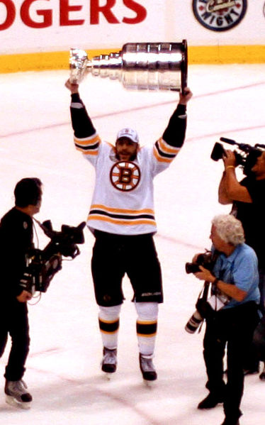 Boston Bruins forward Milan Lucic celebrates with the Stanley Cup after his team's Game 7 win against the Vancouver Canucks on June 15, 2011