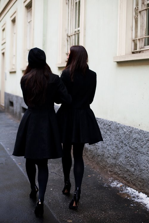 Two ladies on black coat 