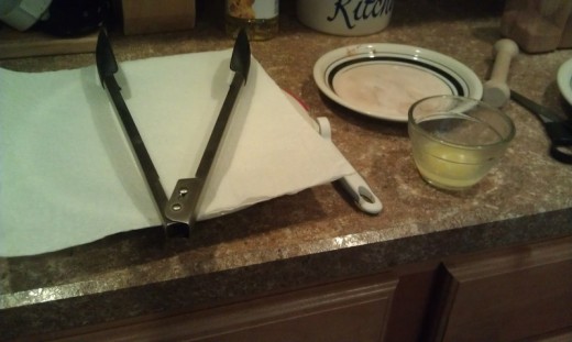 ready to make donuts, paper towel, tongs, butter, sugar mixture on plate