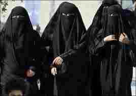 Group of Saudi women.  Full body coverup not seen so often in Britain and this look is feared by many